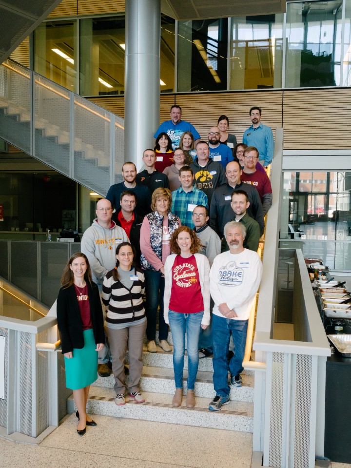 A group of 23 teachers stand on a staircase at Iowa State University for a picture during NewBoCo's professional development training