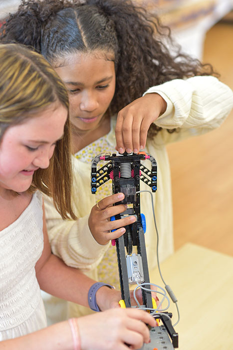 Two CoderDojo students assemble the programmable Robot Arm