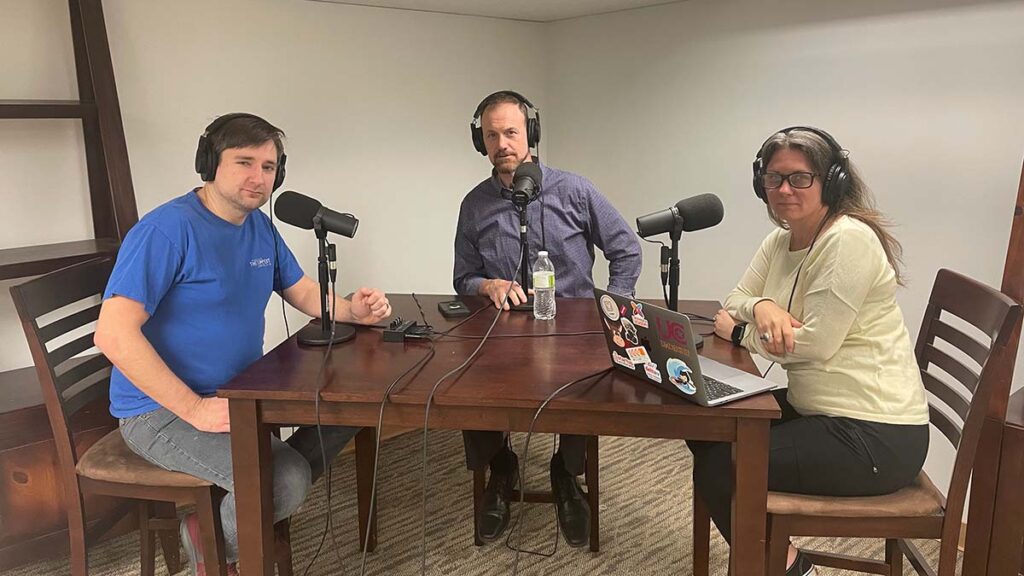 In the studio: Dr. Jennifer Murphy and Not-a-Doctor Rob Merritt, cohosts of Iowa Innovation podcast powered by NewBoCo, pose with serious expressions along with episode 3 guest and Brucemore historical site CEO, David Janssen