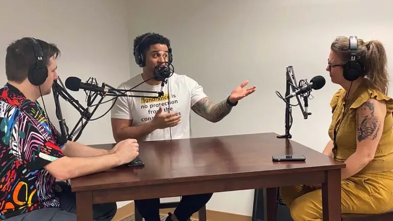 In the studio: Lovar Davis Kidd, found of 100 Percent Over Racism, speaks and gesticulates emphatically while answering a question posed by Dr. Jennifer Murphy. Dr. Murphy and Rob listen attentively.