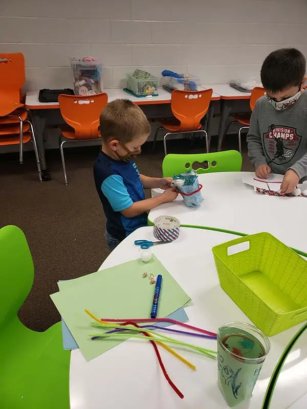Young Fort Madison Community School District students work diligently to assemble CSforALL robotics projects.