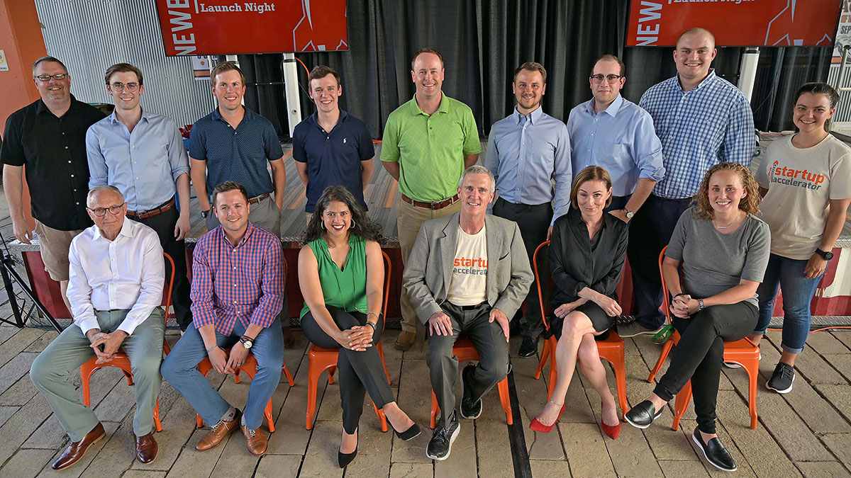 15 Iowa Startup Accelerator participants and staff smile and pose for a group photo