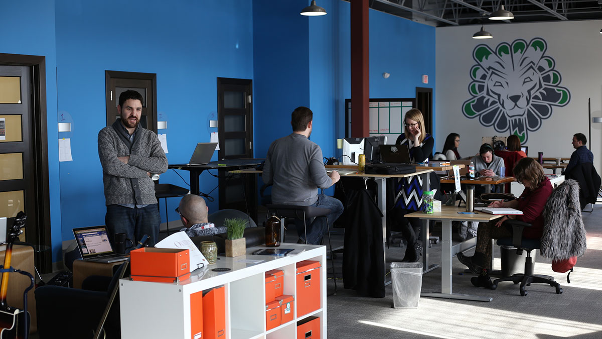 People work and chat in Vault Coworking's open office space.