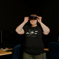 NewBoCo UX designer, Jess Bertling, prototypes a VR goggle experience in a dark room